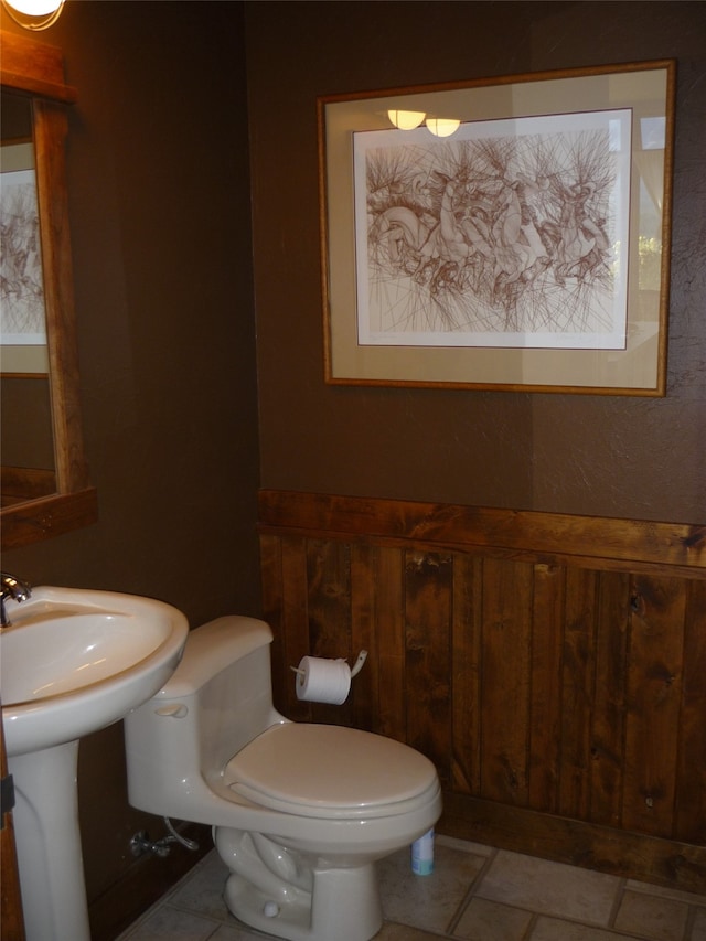 bathroom featuring toilet and tile patterned flooring