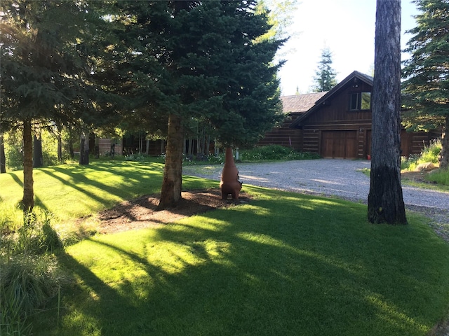 1350 Summit Park, Seeley Lake, MT 59868 - view of green lawn featuring driveway and a garage