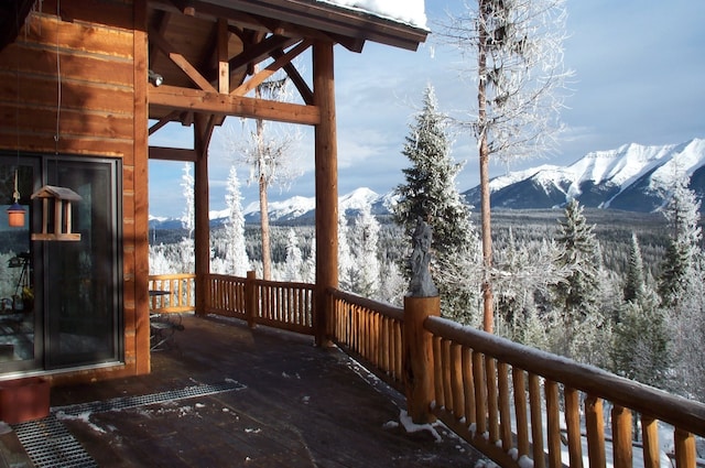 snow covered deck featuring a mountain view