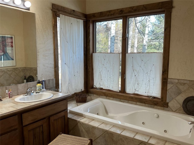 1350 Summit Park, Seeley Lake, MT 59868 - full bathroom with plenty of natural light, a whirlpool tub, vanity, and wainscoting