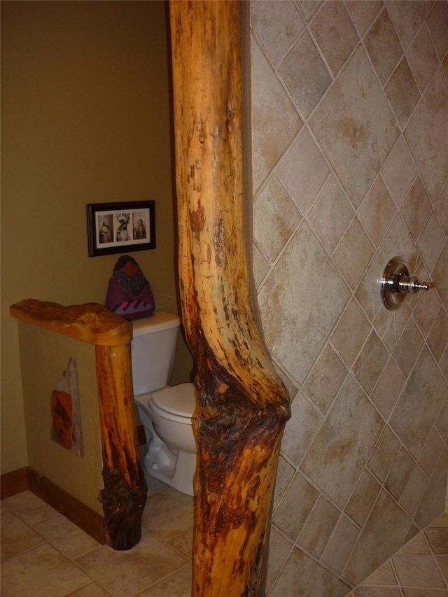 1350 Summit Park, Seeley Lake, MT 59868 - bathroom with toilet, tile patterned floors, tiled shower, and baseboards