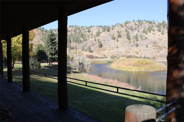 exterior space with a water and mountain view