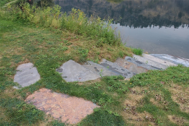 view of side of property featuring a yard and a water view