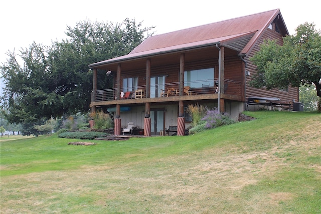 26 N Cooper Ln, Cascade, MT 59421 - rear view of property featuring metal roof, log veneer siding, central AC, and a lawn