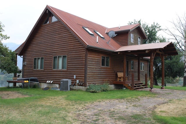 26 N Cooper Ln, Cascade, MT 59421 - view of side of property with central AC unit, metal roof, log veneer siding, and a lawn