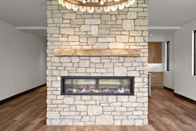 311 Akers Ln Unit D, Whitefish, MT 59937 - detailed view of baseboards, a stone fireplace, and wood finished floors