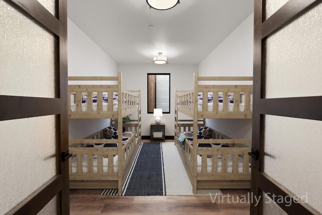311 Akers Ln Unit D, Whitefish, MT 59937 - stairs featuring wood finished floors and vaulted ceiling