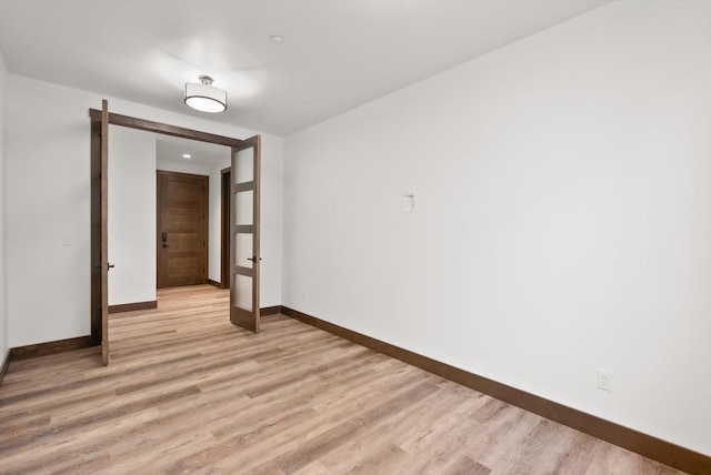 311 Akers Ln Unit D, Whitefish, MT 59937 - spare room featuring baseboards, light wood-style floors, and french doors