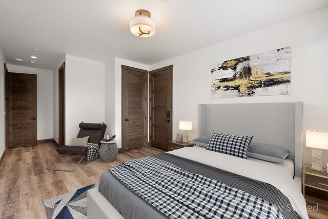 bedroom featuring baseboards and wood finished floors