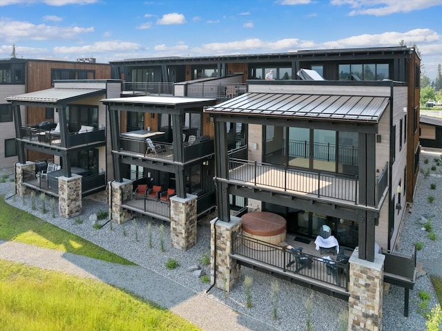 back of property featuring metal roof and a standing seam roof