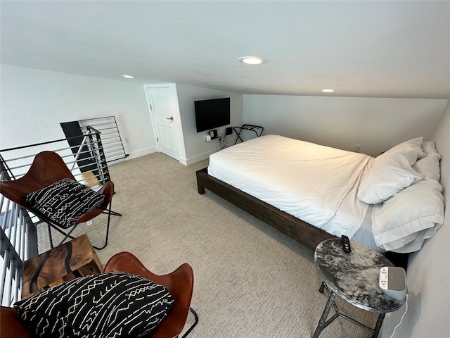 bedroom with lofted ceiling and light colored carpet