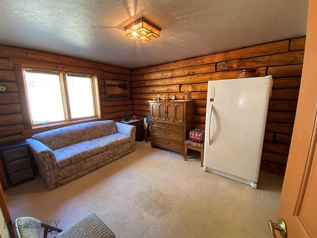 carpeted bedroom featuring white refrigerator, a textured ceiling, and rustic walls