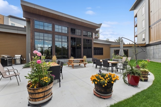 view of patio / terrace featuring area for grilling and an outdoor living space with a fire pit