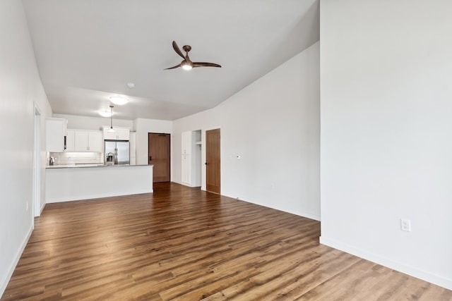 unfurnished living room with ceiling fan and hardwood / wood-style floors