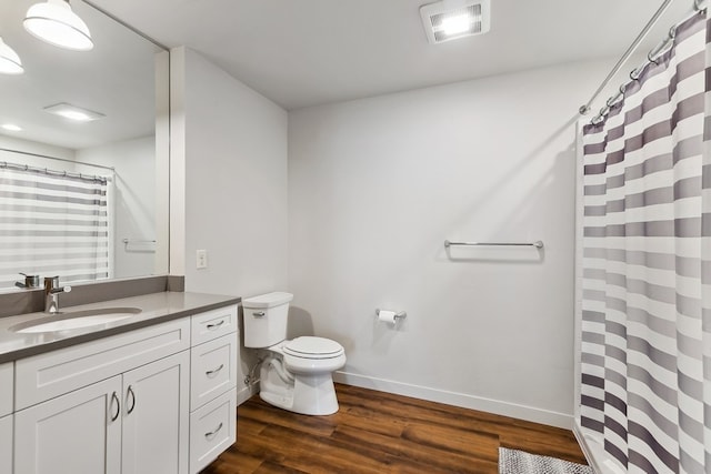 bathroom with oversized vanity, toilet, and hardwood / wood-style flooring