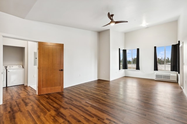 empty room featuring dark hardwood / wood-style flooring, ceiling fan, and washing machine and dryer