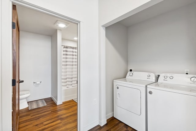 laundry area with dark hardwood / wood-style floors and independent washer and dryer