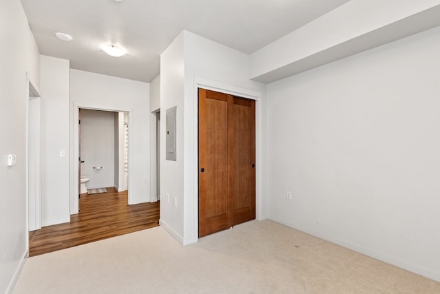 unfurnished bedroom with a closet and hardwood / wood-style flooring