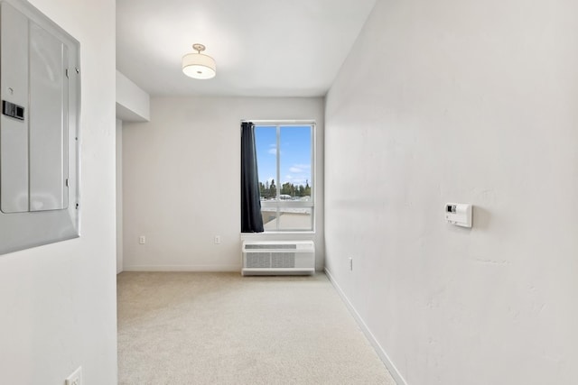 corridor with light colored carpet and a wall mounted AC