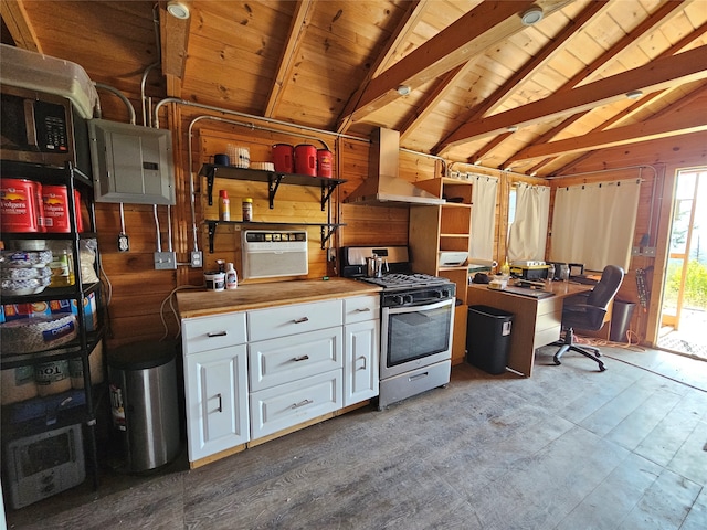 kitchen with island range hood, wooden walls, butcher block countertops, white cabinets, and stainless steel gas range