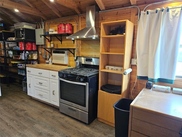 kitchen featuring white cabinetry, lofted ceiling with beams, stainless steel range with gas stovetop, dark hardwood / wood-style flooring, and wall chimney range hood