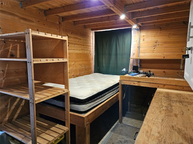 bedroom featuring wooden walls, beam ceiling, and wooden ceiling