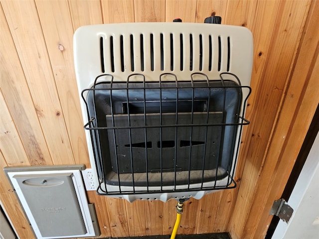 interior details with heating unit and wood walls