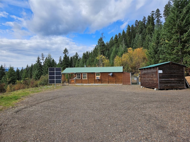 view of front of property featuring solar panels