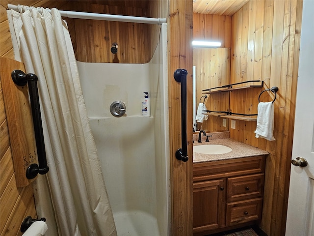 bathroom featuring vanity, curtained shower, and wood walls