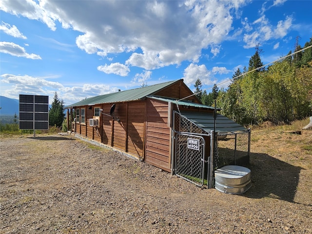 view of outbuilding with cooling unit and solar panels