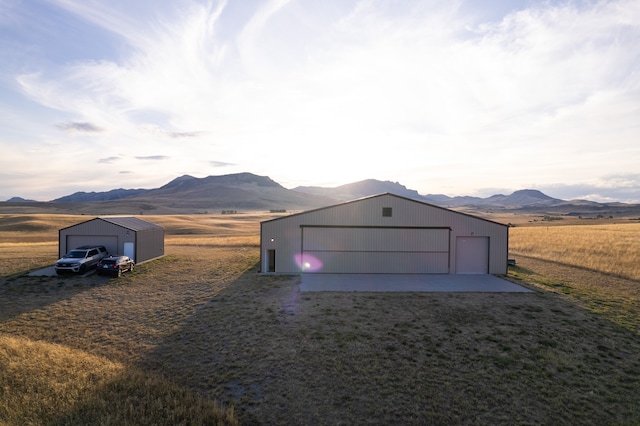 garage featuring a rural view and a mountain view