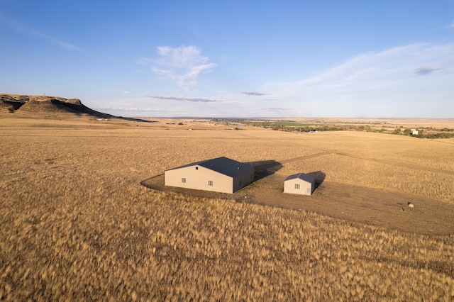 birds eye view of property with a rural view