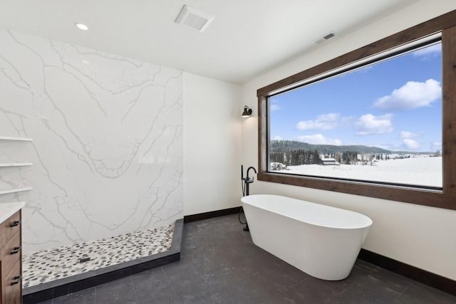 bathroom featuring a tub to relax in, a mountain view, and vanity