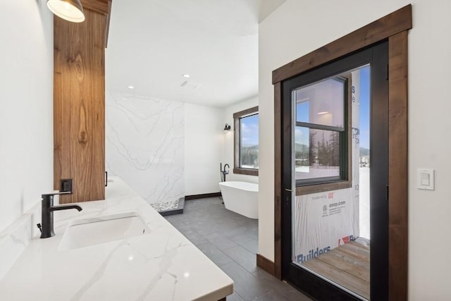 bathroom with vanity and a tub to relax in