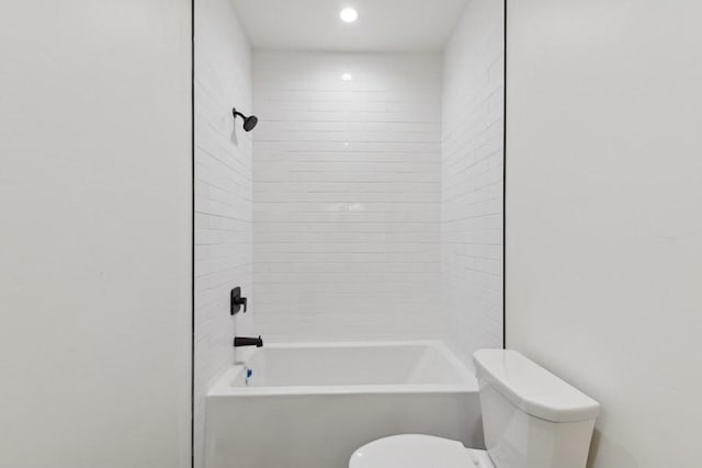 bathroom featuring toilet and tiled shower / bath combo