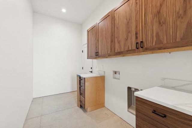 laundry room featuring washer hookup and cabinets