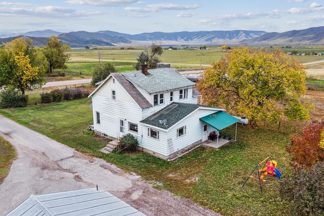 drone / aerial view featuring a mountain view and a rural view