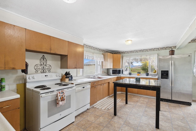 kitchen with sink, stainless steel appliances, and light tile floors