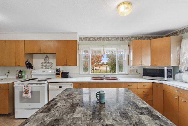 kitchen featuring white appliances and sink