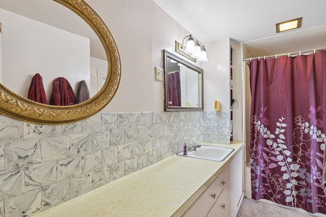 bathroom with tasteful backsplash, vanity with extensive cabinet space, and tile walls