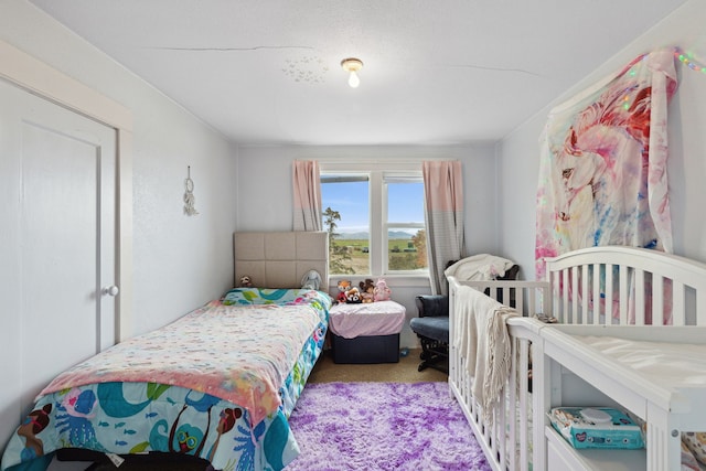 bedroom featuring light carpet