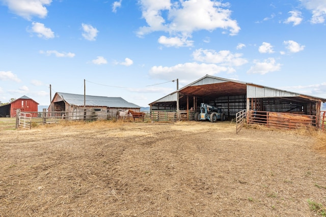 view of yard with a rural view and an outdoor structure