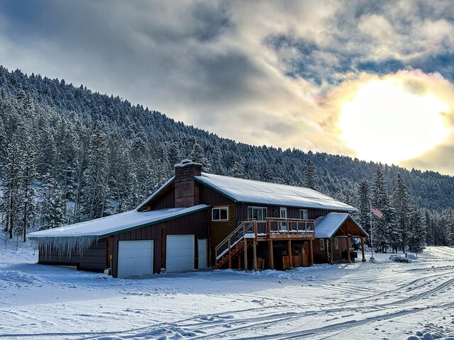 425 Lagger Gulch Rd, Anaconda, MT 59711 - exterior space with a chimney, stairway, a forest view, and a detached garage