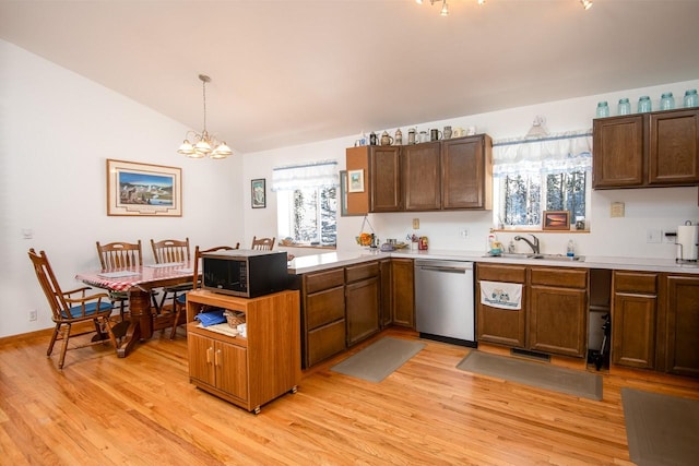 425 Lagger Gulch Rd, Anaconda, MT 59711 - kitchen featuring a sink, a peninsula, stainless steel appliances, light wood-type flooring, and an inviting chandelier
