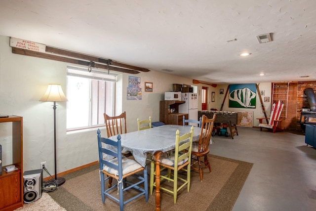 425 Lagger Gulch Rd, Anaconda, MT 59711 - dining space featuring a wood stove, concrete flooring, and recessed lighting