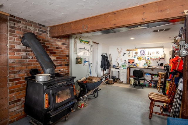 425 Lagger Gulch Rd, Anaconda, MT 59711 - finished below grade area with a workshop area, a wood stove, and visible vents