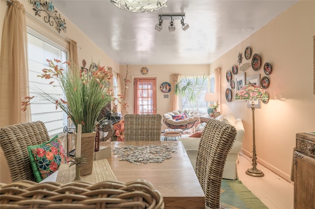 dining space featuring wood finished floors and baseboards