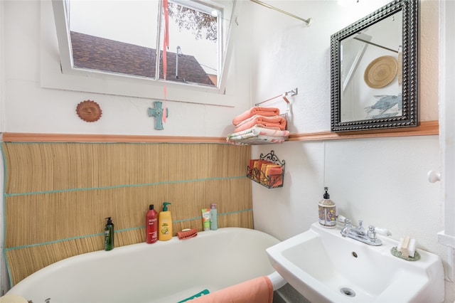 full bathroom featuring a sink and a soaking tub