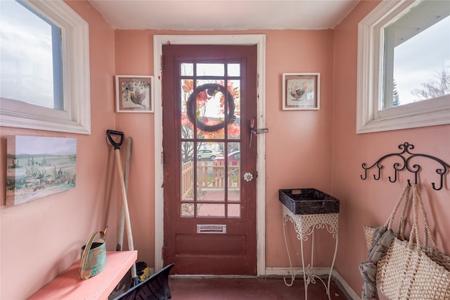 doorway featuring baseboards