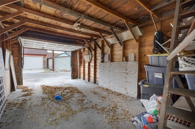 misc room featuring a garage and vaulted ceiling